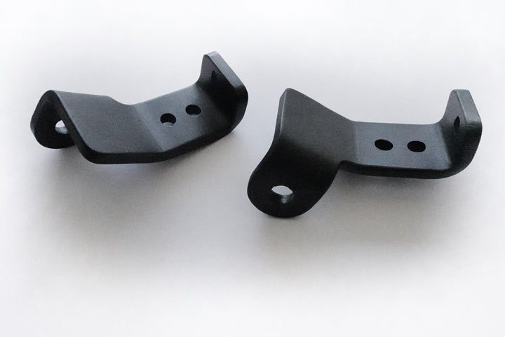 Pair of black powder-coated metal brackets designed as BPF 2024+ Tacoma Recovery Points for secure and durable vehicle recovery attachment.