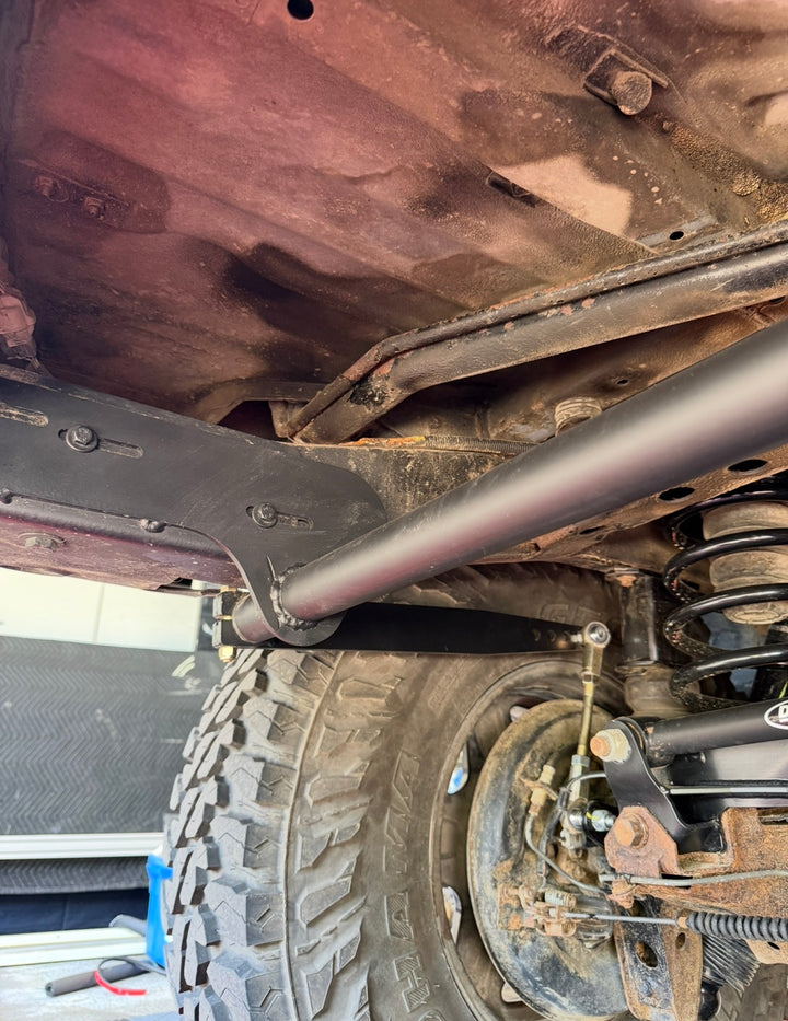 BPF 80 Series Land Cruiser RockJock AntiRock Frame Mounting Plates shown installed beneath a Land Cruiser with reinforced frame and suspension components