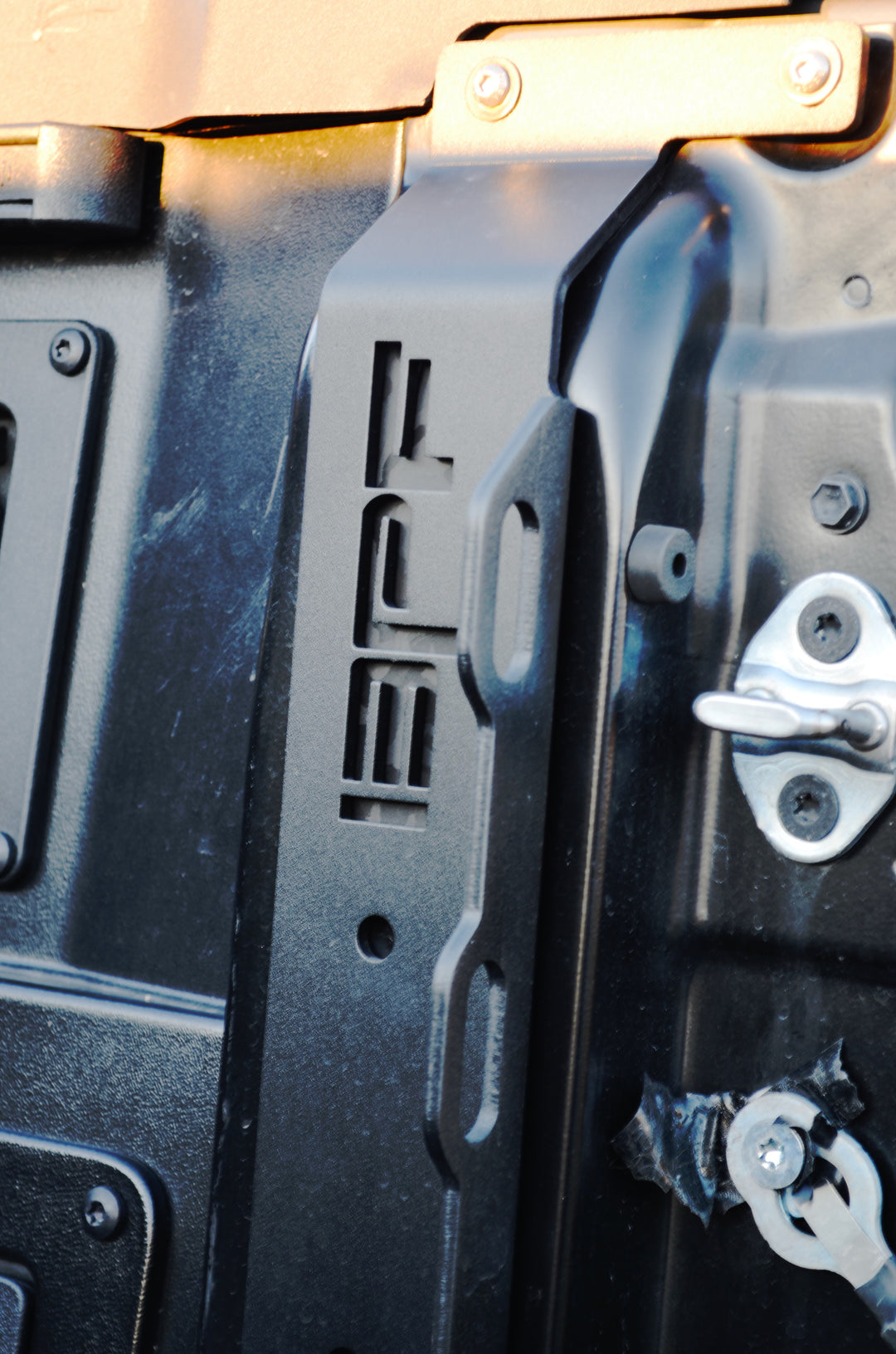 Close-up view of black metal BPF 2024-2025 Toyota Tacoma Bed Stiffeners installed on a truck bed, featuring a powder-coated finish and precise CNC fabrication for enhanced durability and OEM fitment.