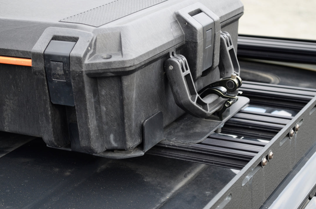 BPF Universal Pelican Vault V700 Case Mounting brackets securely hold a rugged Pelican Vault V700 case on a durable metal rack, showcasing heavy-duty CNC fabricated overlanding gear.