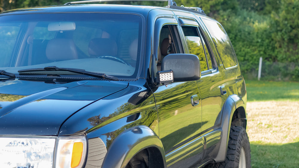 Black 1996-2002 Toyota 4Runner equipped with BPF 1996-2002 Toyota 4Runner Light Brackets mounted near the side mirrors, showcasing durable, CNC fabricated off-road accessory.