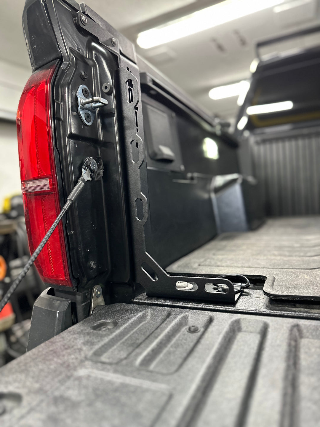 Close-up of BPF 2024-2025 Toyota Tacoma Bed Stiffeners installed on the truck bed edge, showing black powder coated steel construction and secure fitment.