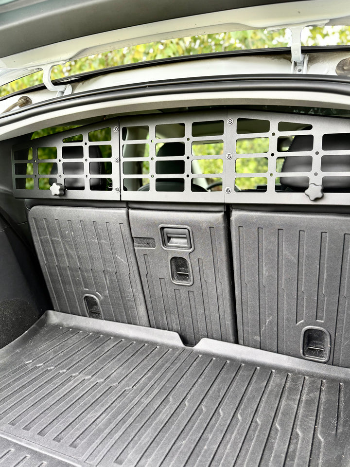 BPF Molle Style Pet Barrier Tesla Model Y 2020-CURRENT installed behind rear seats, black metal grid design for secure separation and durable protection inside the cargo area.