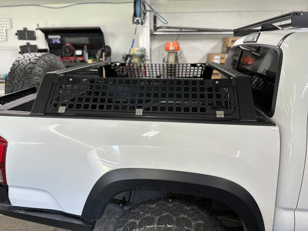 05-26 Tacoma Bed Rack fits 2nd,3rd and 4th gen Tacomas installed on white truck bed with black mesh storage panels in workshop environment
