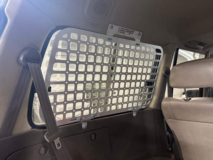BPF 1990-1997 Toyota Land Cruiser Storage Panels installed inside vehicle with perforated metal design for secure and organized overlanding gear storage.