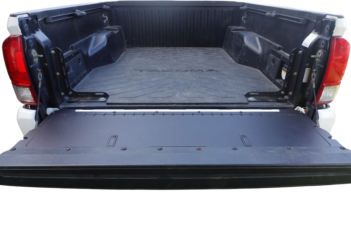 Open truck bed showcasing the installed BPF 2016-2023 Toyota Tacoma Tailgate Panel in a powder-coated black finish, designed for OEM fitment and durability.