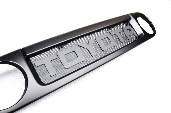 BPF Completed 2007-2014 FJ Cruiser Grill in black with a textured mesh background and bold TOYOTA lettering, designed for OEM fitment and durable performance.