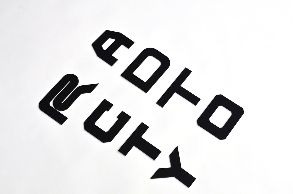 BPF Grill Lettering consisting of bold, stylized black metal letters designed for custom automotive grills, showcasing a modern and durable finish.