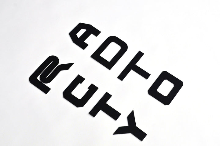 BPF Grill Lettering consisting of bold, stylized black metal letters designed for custom automotive grills, showcasing a modern and durable finish.