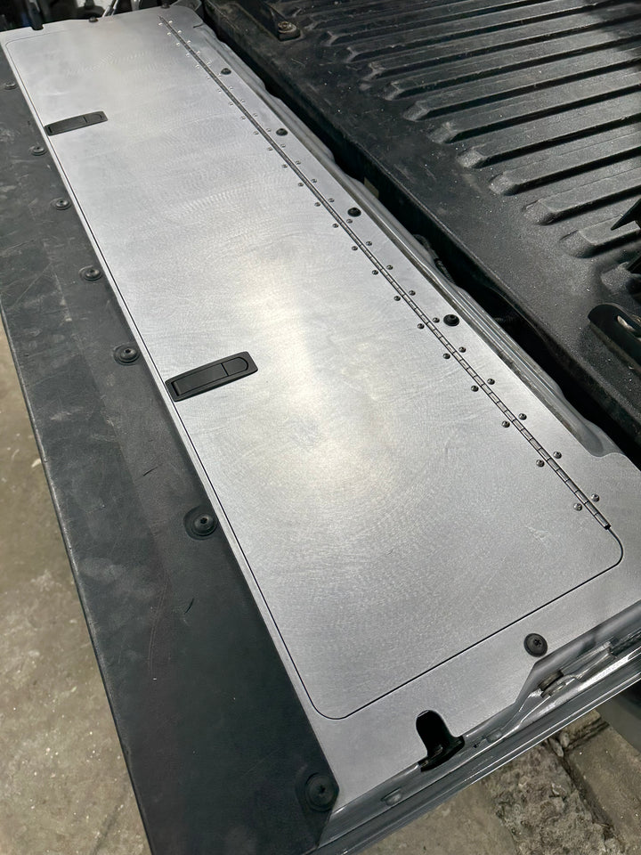 BPF 2016-2023 Toyota Tacoma Tailgate Panel installed on truck tailgate, featuring a durable, powder-coated metal finish with OEM fitment and secure locking handles.