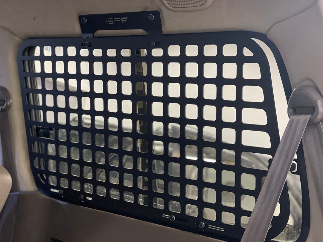 BPF 1990-1997 Toyota Land Cruiser Storage Panels installed inside the vehicle with a grid pattern for secure overlanding gear storage and pet barrier functionality.