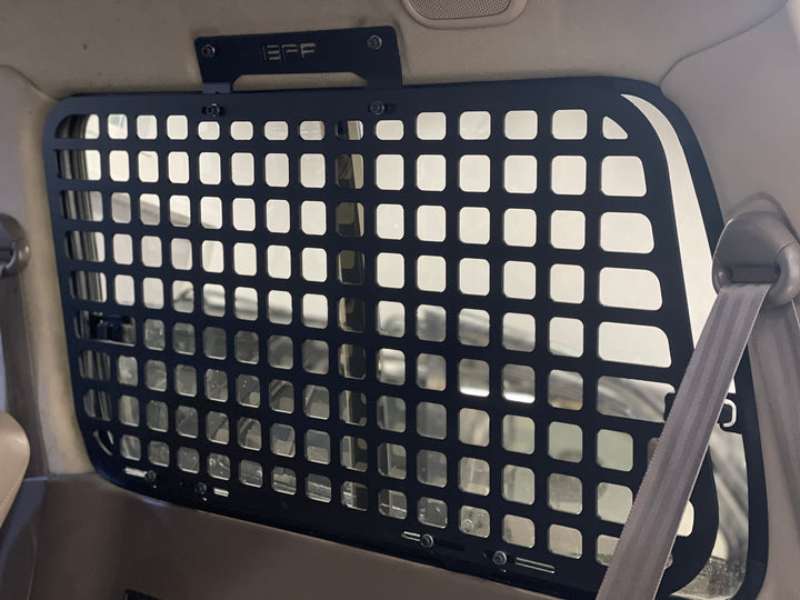 BPF 1990-1997 Toyota Land Cruiser Storage Panels installed inside the vehicle with a grid pattern for secure overlanding gear storage and pet barrier functionality.
