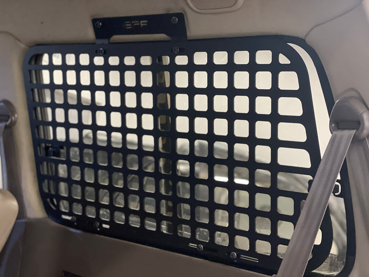 BPF 1990-1997 Toyota Land Cruiser Storage Panels installed inside vehicle, featuring durable black powder-coated grid design for secure overlanding gear and storage organization.