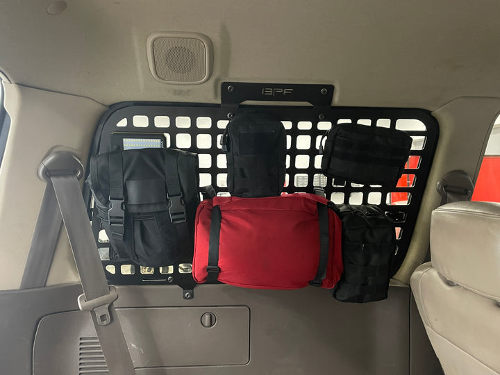 BPF 1990-1997 Toyota Land Cruiser Storage Panels installed inside vehicle with multiple black and red storage pouches attached for organized overlanding gear and accessories.