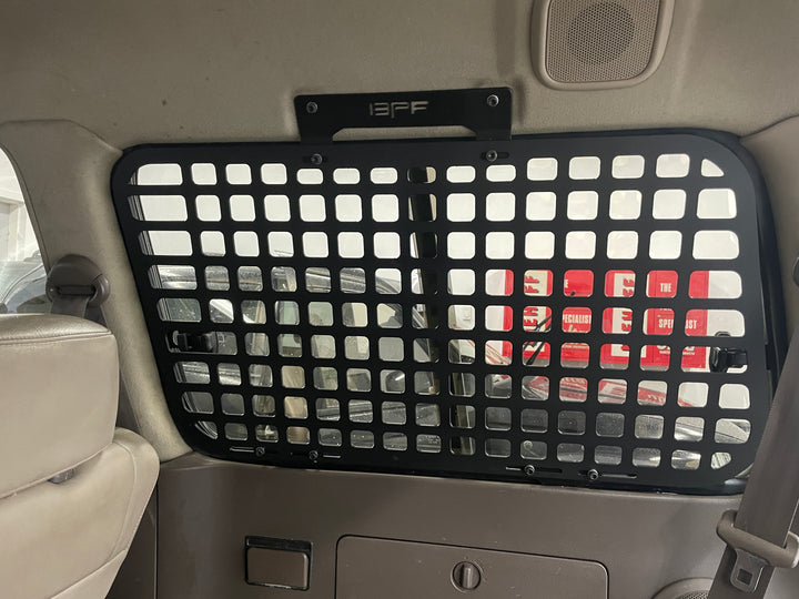 BPF 1990-1997 Toyota Land Cruiser Storage Panels installed inside vehicle rear cargo area, featuring black powder-coated grid design for secure storage and organization.