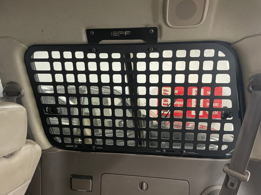 BPF 1990-1997 Toyota Land Cruiser Storage Panels installed inside vehicle, featuring a sturdy black metal grid design for secure overlanding gear organization and tool-free install.