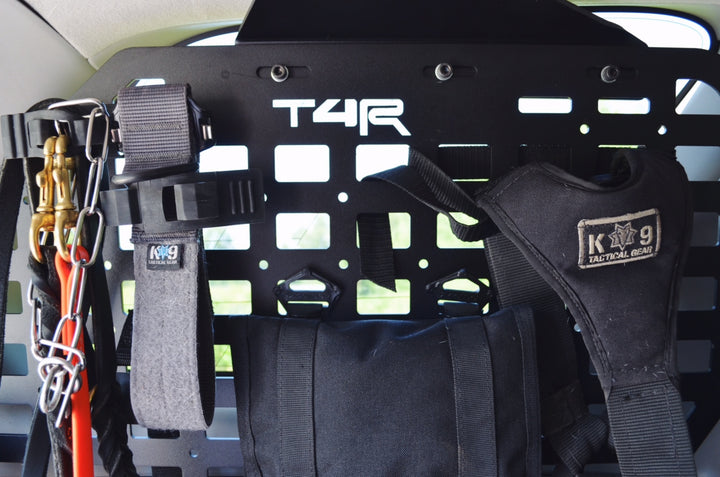 Interior view of a vehicle fitted with BPF 2010-2024 4Runner Storage Panels featuring mounted tactical gear and accessory straps for organized overlanding and outdoor equipment storage.