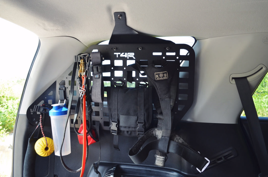 Interior view of a 4Runner showcasing BPF 2010-2024 4Runner Storage Panels installed on the side wall with various gear and straps attached for organized overlanding storage.