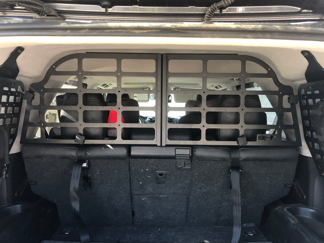 BPF Molle Style Pet Barrier 5th Gen Toyota 4Runner 2010-2024 installed behind rear seats, featuring durable black metal mesh design to keep pets secure in vehicle cargo area.