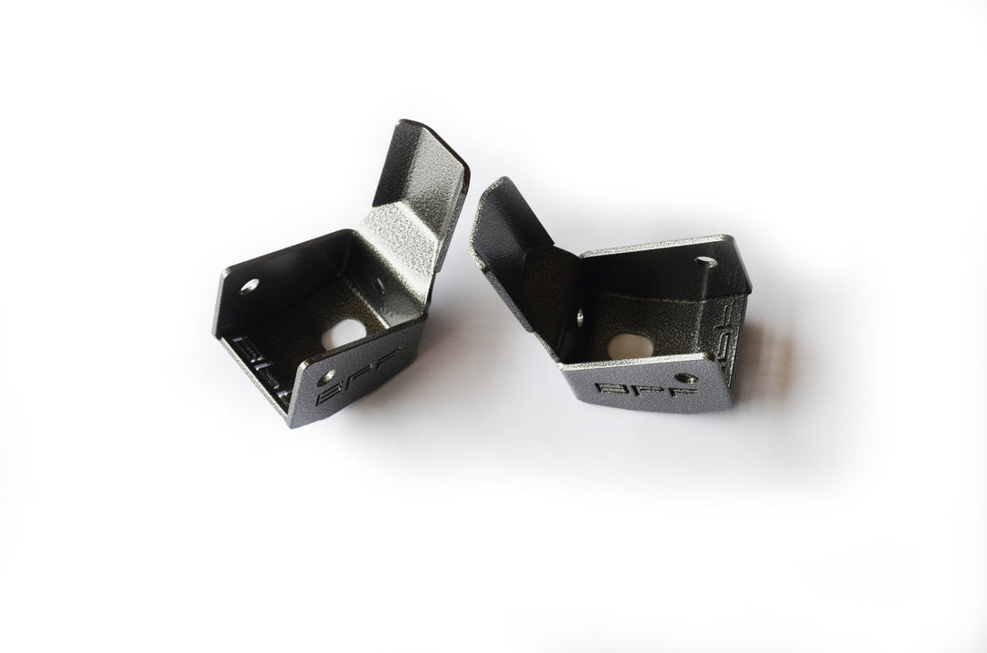 Pair of black powder-coated metal brackets designed for durability and protection with BPF 4runner 04-24/FJ 07-14 Shock Guards, CNC fabricated for precise OEM fitment.