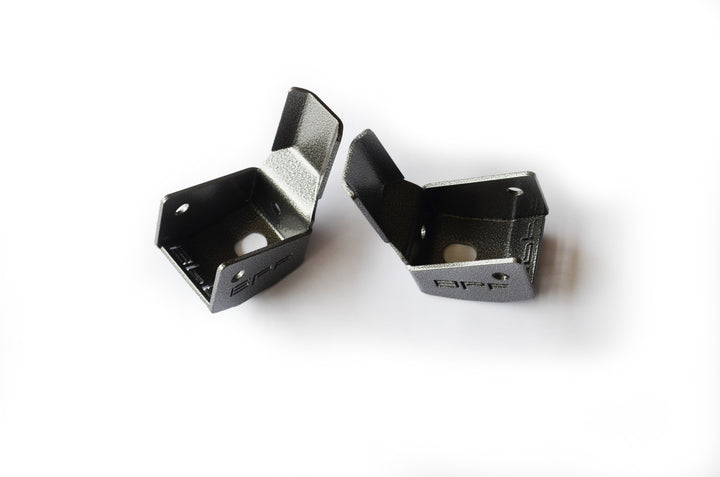 Pair of black powder-coated metal brackets designed for durability and protection with BPF 4runner 04-24/FJ 07-14 Shock Guards, CNC fabricated for precise OEM fitment.