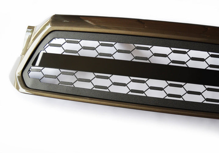 Close-up of a honeycomb pattern black metal BPF 2012-2015 Toyota Tacoma Grill with a solid central bar, designed for durable OEM fitment and style upgrade.