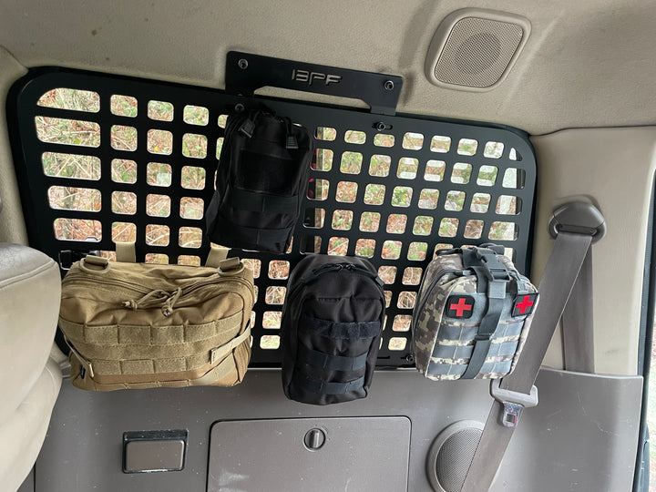 BPF 1990-1997 Toyota Land Cruiser Storage Panels installed inside a vehicle with MOLLE pouches attached, showing a durable, powder-coated metal panel designed for organized storage and overlanding gear.